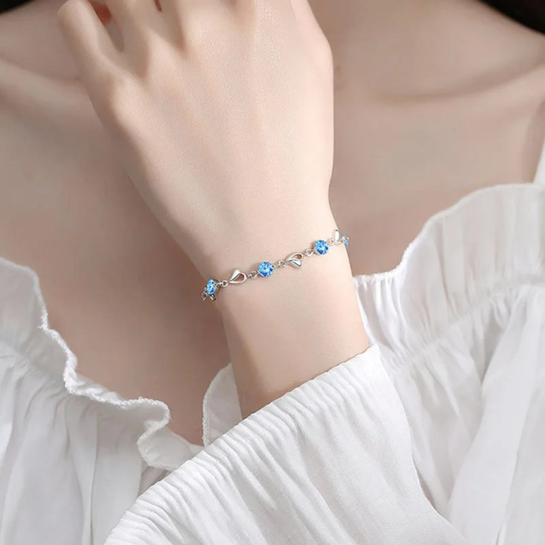 Elegant Silver Heart Charm Bracelet with Sparkling Blue Crystals